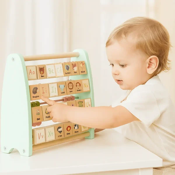 baby touching wooden abacus