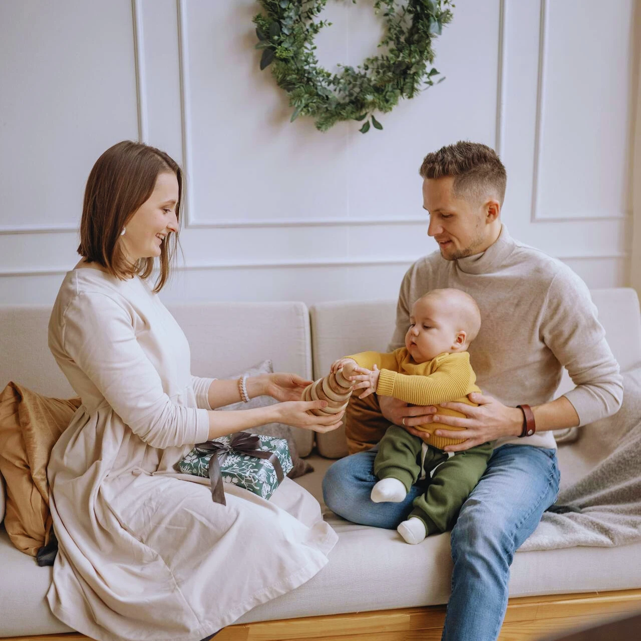 montessori-toys-dubai Parents giving Montessori wooden toys in Dubai to little baby boy